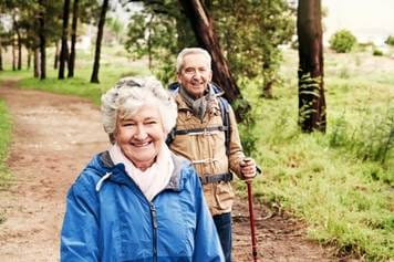 House of Hearing Richfield Utah - An older couple hiking in the woods.